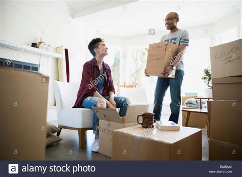Couple Unpacking Belongings From Moving Boxes Stock Photo Alamy