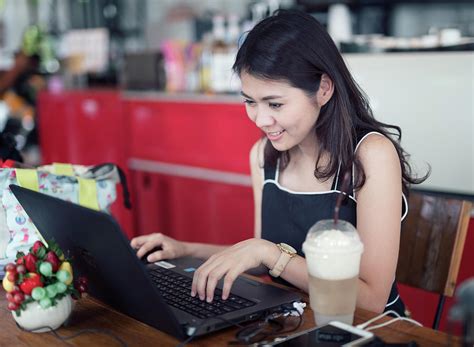 Asian Woman Working With Computer And Drinking Ice Coffee Photograph By