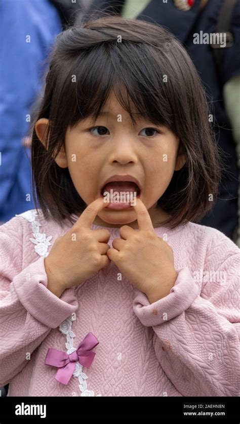 Japanese Girl Making A Face By Pulling Her Mouth Tokyo Japan Stock