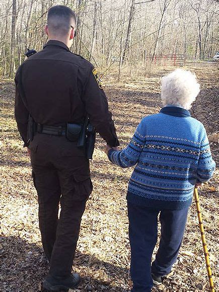 police officer holds hand of woman with dementia