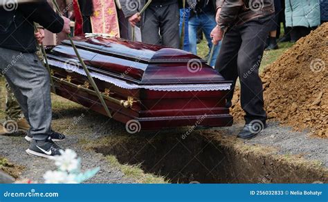 Burial Men Lower The Coffin Into The Grave N Stock Image Image Of