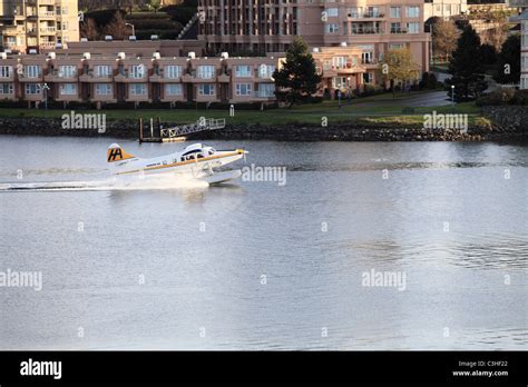 A Sightseeing Pontoon Plane Landing On The Water Of Victoria Harbor In