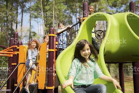 Elementary Children Play At School Recess Or Park On Playground Stock