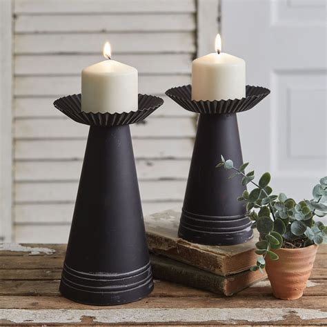 This Set Of Two Candle Holders Feature Corrugated Edges And A Pillar