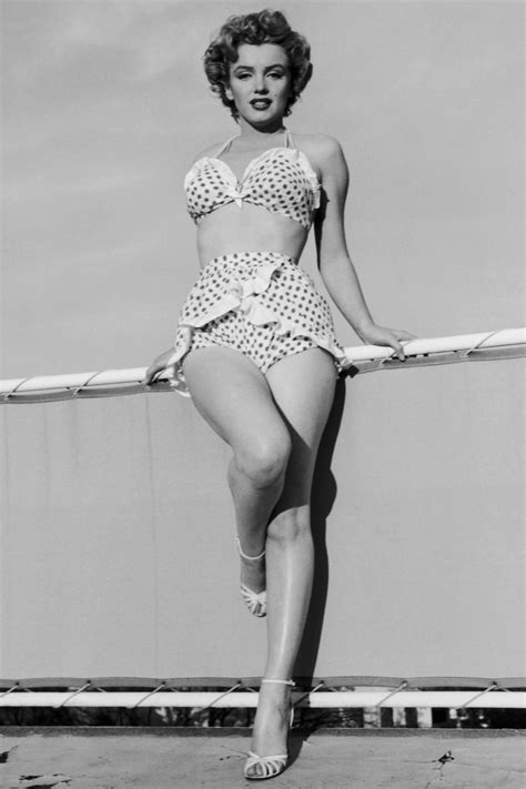 A Woman In A Bathing Suit Standing On A Pole