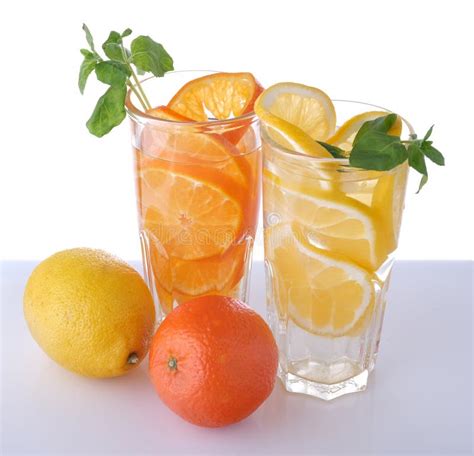 Two Glasses With Lemon And Tangerine Drink And Fruits Stock Image