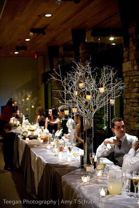 Using tree branches as centerpieces for your table is a great way to add texture, style, beauty and interest into any room of your home. Tall branch w hanging votives | Diy wedding centerpieces branches, Branch centerpieces wedding ...