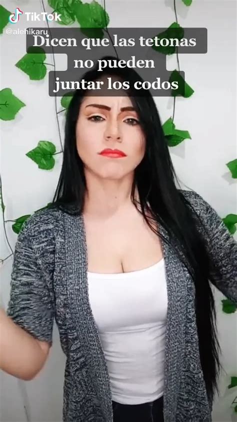 Tiktok User Alehikaru Squeezing Her Clothed Boobs Together With Her Arms Showing Her Cleavage