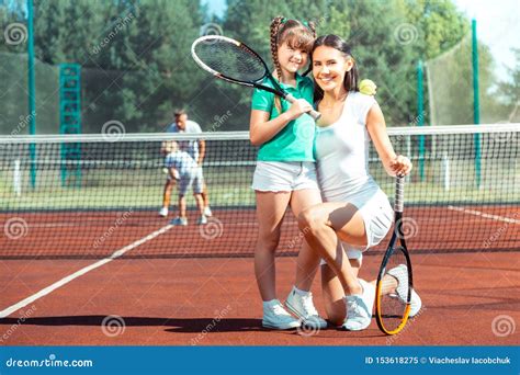 Mother Smiling Broadly Before Playing Tennis With Daughter Stock Image Image Of Excited