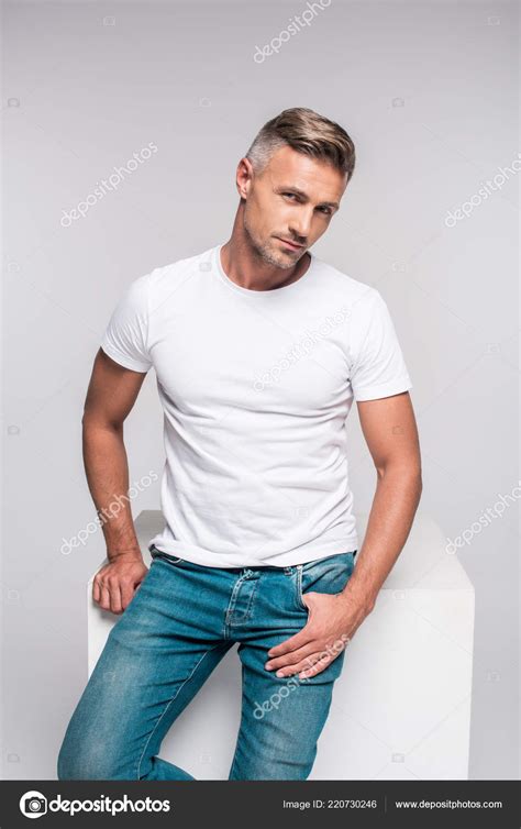 Portrait Handsome Man Denim Pants White Shirt Sitting Looking Camera