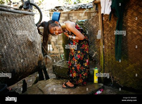 A Longneck Girl Showers Outside Her Home Approximately 300 Burmese