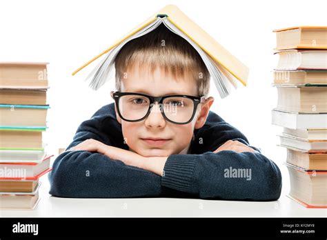 Close Up Portrait Of A Smart Schoolboy Wearing Glasses With A Book On
