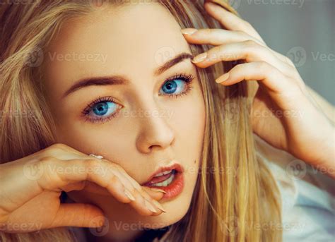 Seductive Blonde Woman With Blue Eyes Looking At Camera 16402301 Stock