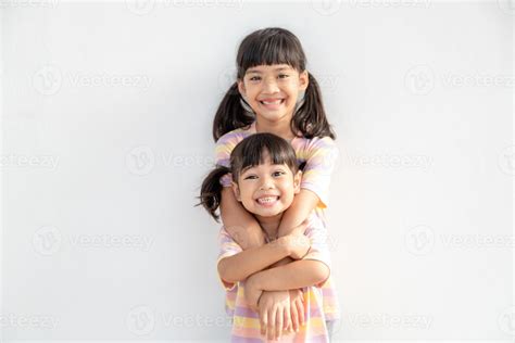 Cute Happy Asian Siblings Hugging Cuddling Feeling Love And Connection