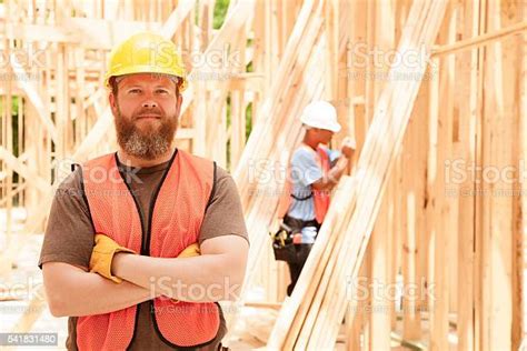 Construction Workers Busy Working At Job Site Framed Building Tools