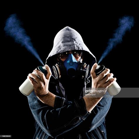 Man Holding Graffiti Spray Paint Cans High Res Stock Photo Getty Images