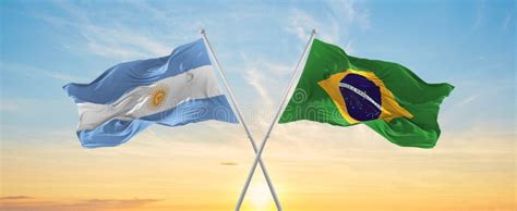 Crossed National Flags Of Argentine And Brazil Flag Waving In Wind At