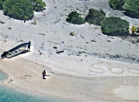 Couple Stranded On Desert Island Rescued After Writing Sos Message In