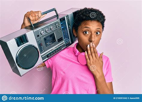 Young African American Girl Holding Boombox Listening To Music