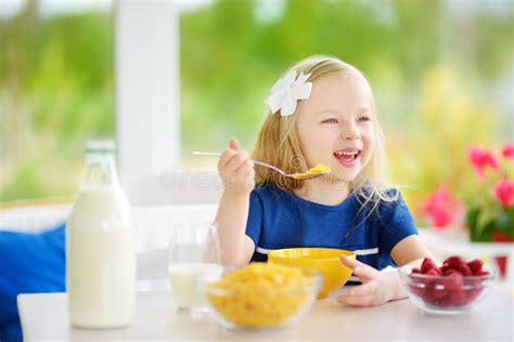 Cute Little Girl Enjoying Her Breakfast At Home Pretty Child Eating