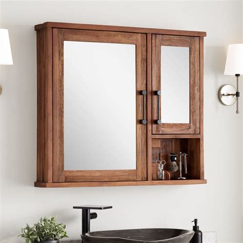 Made of strong wood, and accentuated with glass doors, with metal grips, this cabinet is just fine for the bathroom has white tiled walls with some black décor accents. 36" Helms Reclaimed Teak Medicine Cabinet | Signature ...