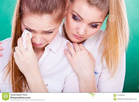 Sad Woman Crying And Being Consoled By Friend Stock Photo
