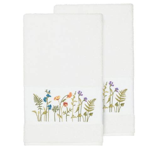Two White Towels With Embroidered Flowers On Them