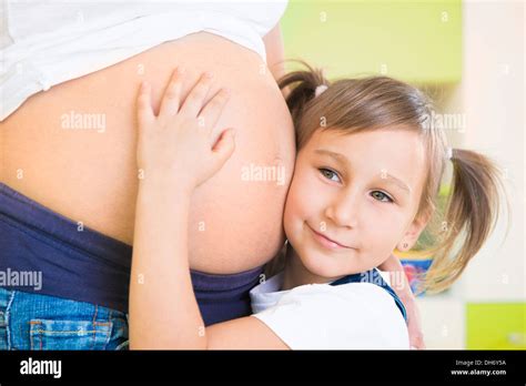 Girl Hugging Mothers Pregnant Belly Hi Res Stock Photography And Images