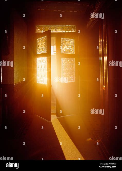 Golden light streaming through open door Stock Photo - Alamy