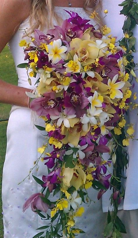 Highly traditional and popular, nosegay bouquets are round bouquets consisting of a tight bunch of flowers cut to uniform in length and style. Kim went all out with this Cascading Tropical Bouquet ...