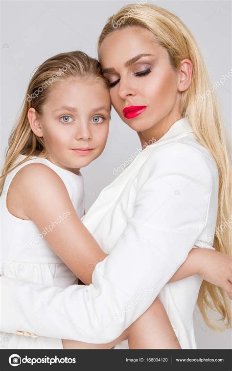 Beautiful Blonde Female Model Mother With Blonde Daughter Hug They