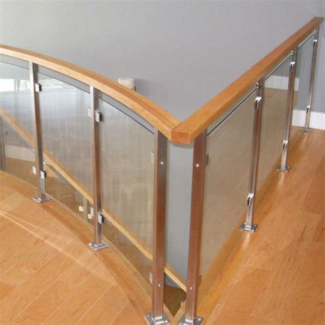 Bronze railing with patina and glass panels. Stainless Steel Glass Railing - Glacier Wood Top from AGS Stainless