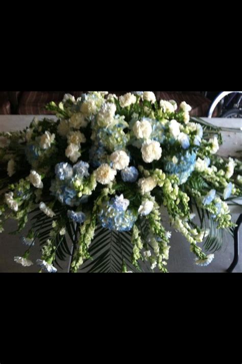 You can also add thoughtful funeral banner for finishing touch. Casket spray blue & white carnations and lt blue hydrangea ...