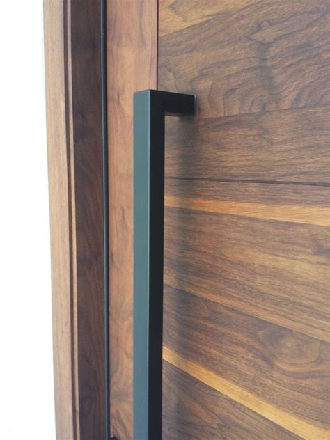 A Close Up Of A Door Handle On A Wooden Door