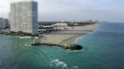 Panoramic Photo Of Gray Sand Beach Near High Rise Building Hd Wallpaper