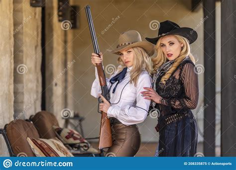 two lovely blonde models dressed as cowgirls enjoys the american west stock image image of