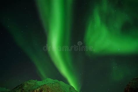 Grainy Green Aurora Northern Lights In The Sky At Mountain Peak In