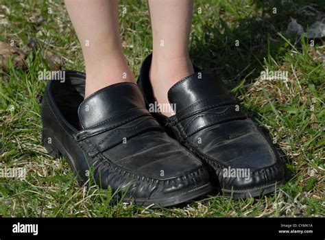 Small Feet In Big Shoes Stock Photo Alamy