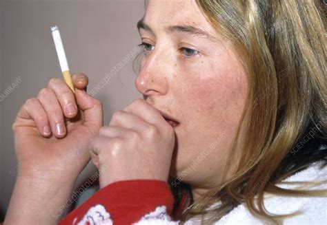 woman coughs while smoking a cigarette stock image m370 0374 science photo library