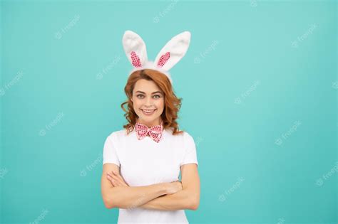 Premium Photo Positive Easter Woman With Bunny Ears On Blue Background