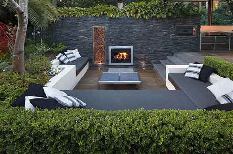 Outdoor Living With Sunken Lounge Lit Fireplace In Stone Wall With