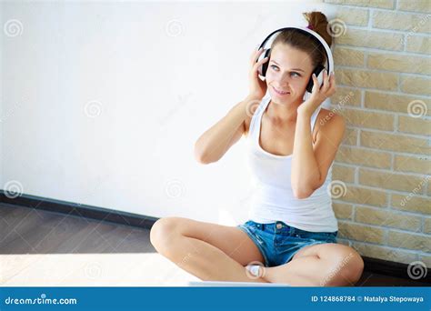 Beautiful Brunette Girl With Headphones Listening To Music While