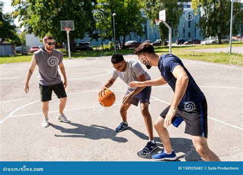 Group Of Male Friends Playing Street Basketball Stock Photo Image Of