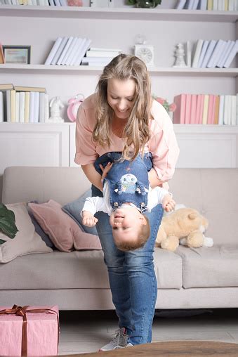 Mother Holds Happy Baby Upside Down Stock Photo Download Image Now