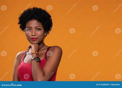 Attractive Beautiful Afro Woman Posing On Orange Studio Background