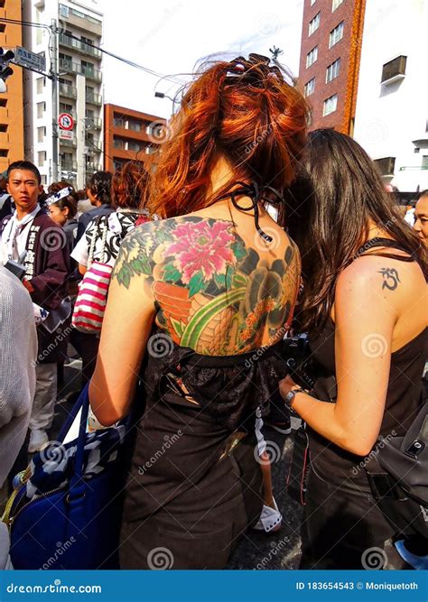 Back View Of A Yakuza Woman Showing Off Her Tattoo During The Sanja