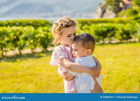 Portrait Of Two Cute Adorable Baby Children Toddlers Hugging And