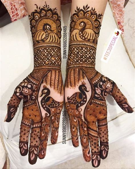 Two Hands With Henna Designs On Them One Is Showing The Intricate