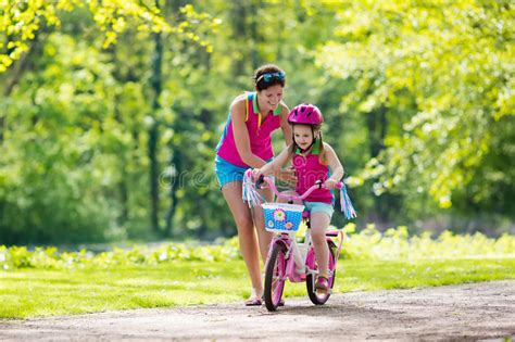 Mother Teaching Child To Ride A Bike Stock Image - Image ...
