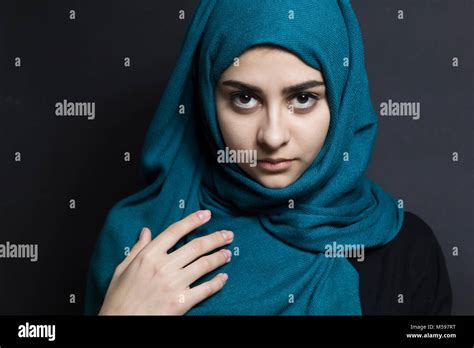 Muslim Beautiful Girl In Hijab Portrait Of An Arab Young Woman On A Black Background Stock